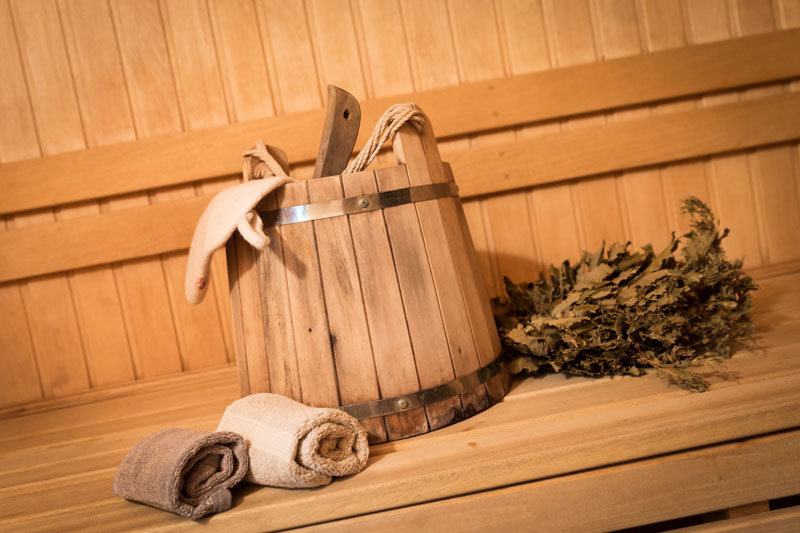 equipment-sauna Loyly and bucket of water on a cedar sauna bench